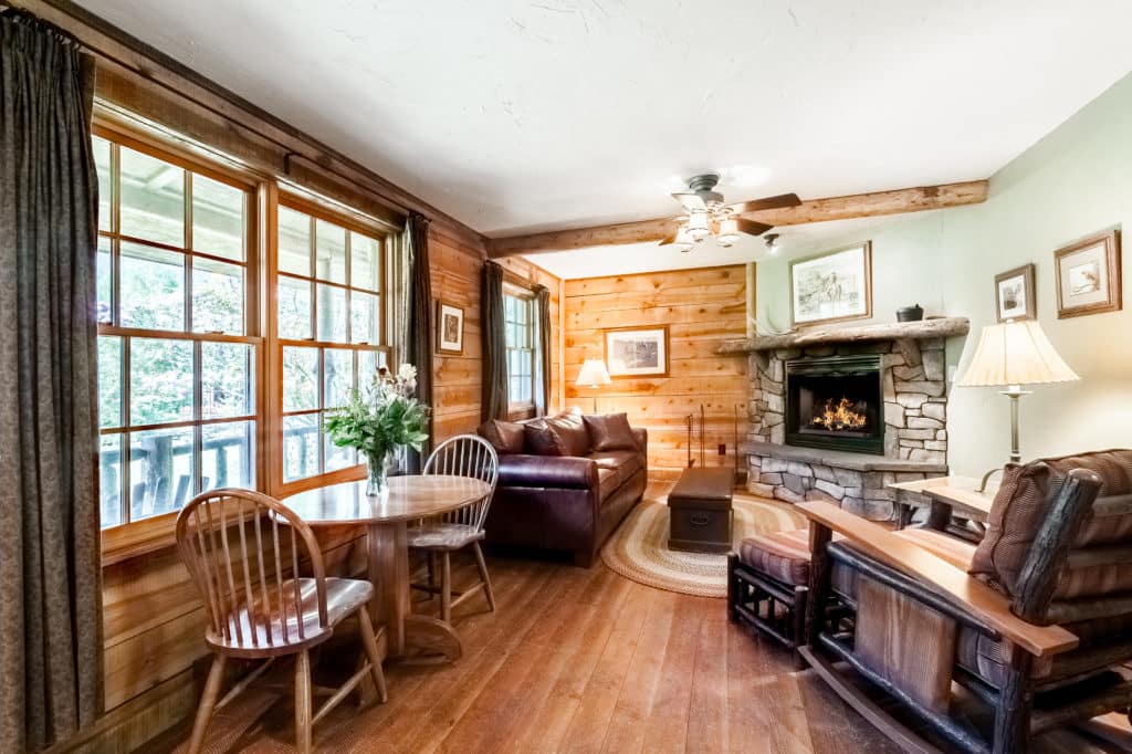 The living room, with couch and recliner chair, at the Garnet cabin at Mountain Sky Guest Ranch