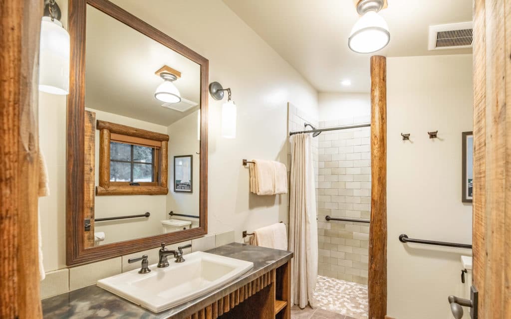 Bathroom sink and shower in the Rimini Cabin at Mountain Sky Guest Ranch