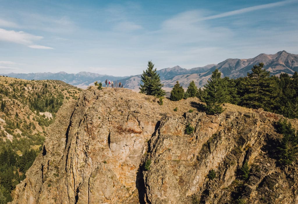 Hikers traversing the rocky landscape around the Mountain Sky Guest Ranch property