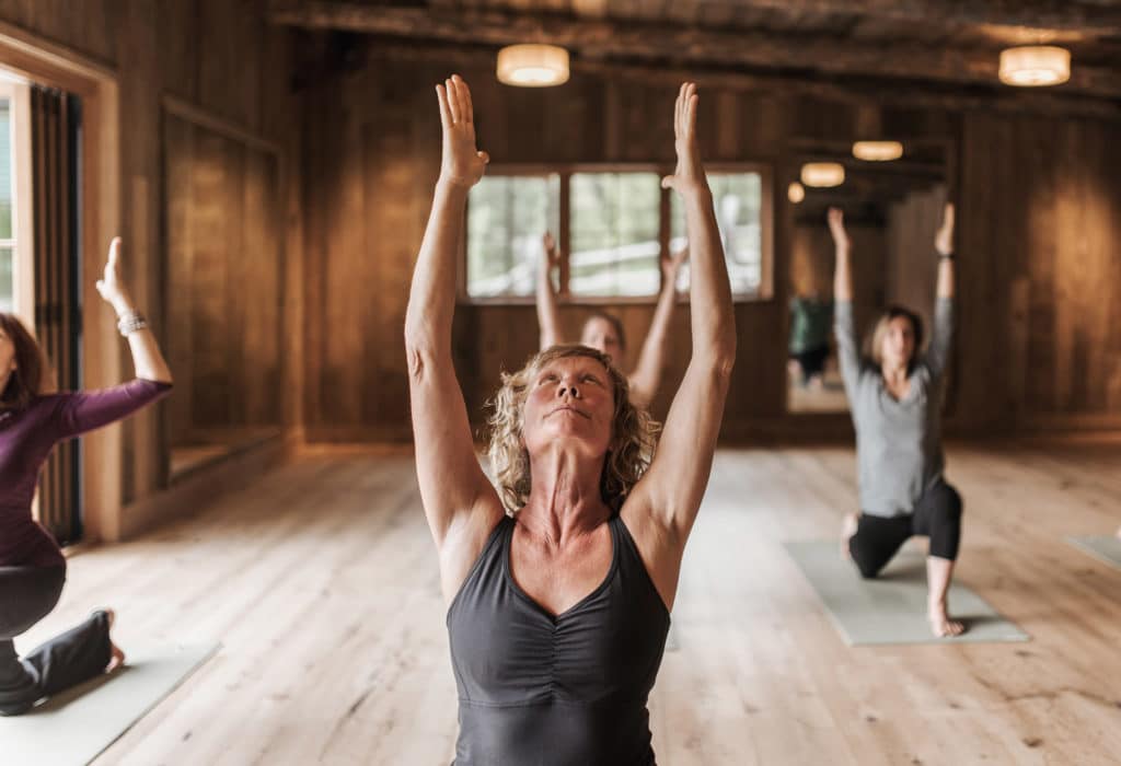 Women doing yoga in Mountain Sky Guest Ranch's yoga center