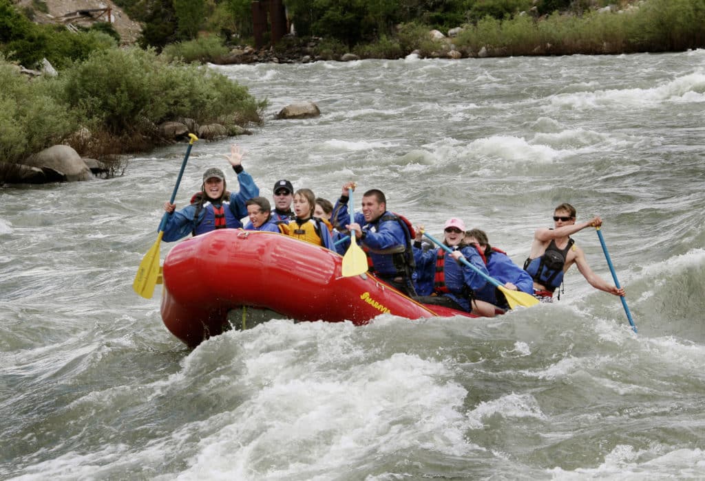 Mountain Sky guests white water rafting down the Yellowstone River with guides